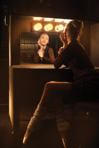 Kara Troester Blythe backstage at a lit dressing mirror