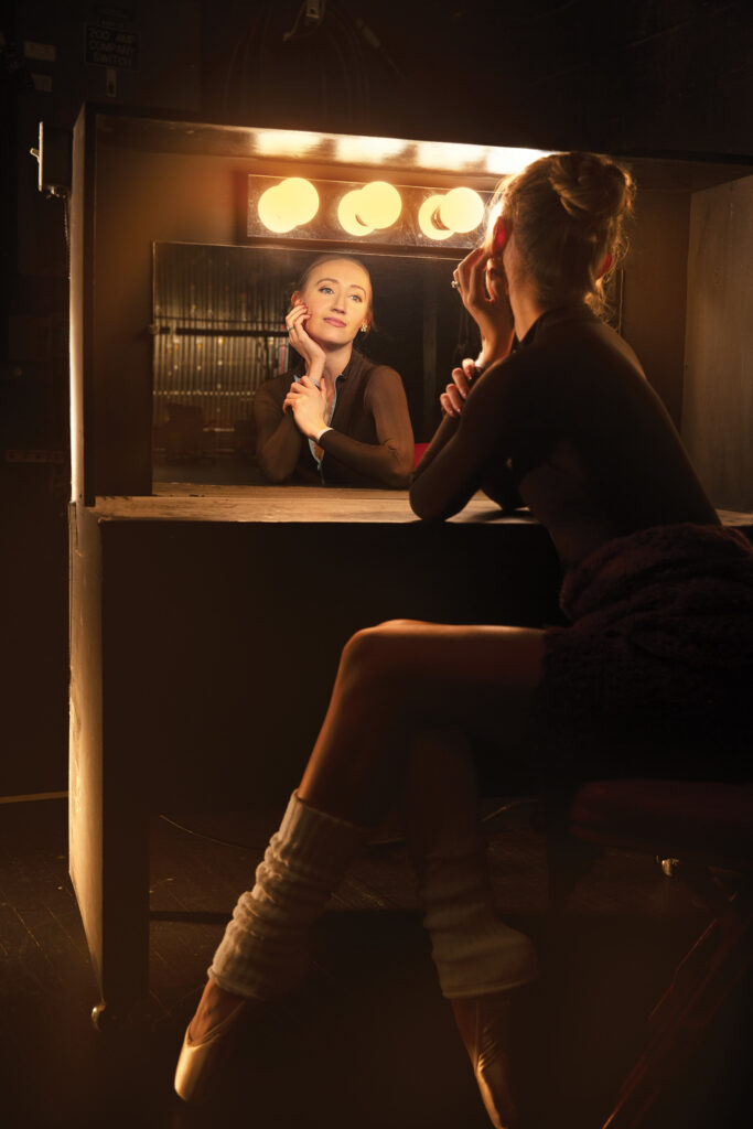 Kara Troester Blythe backstage at a lit dressing mirror
