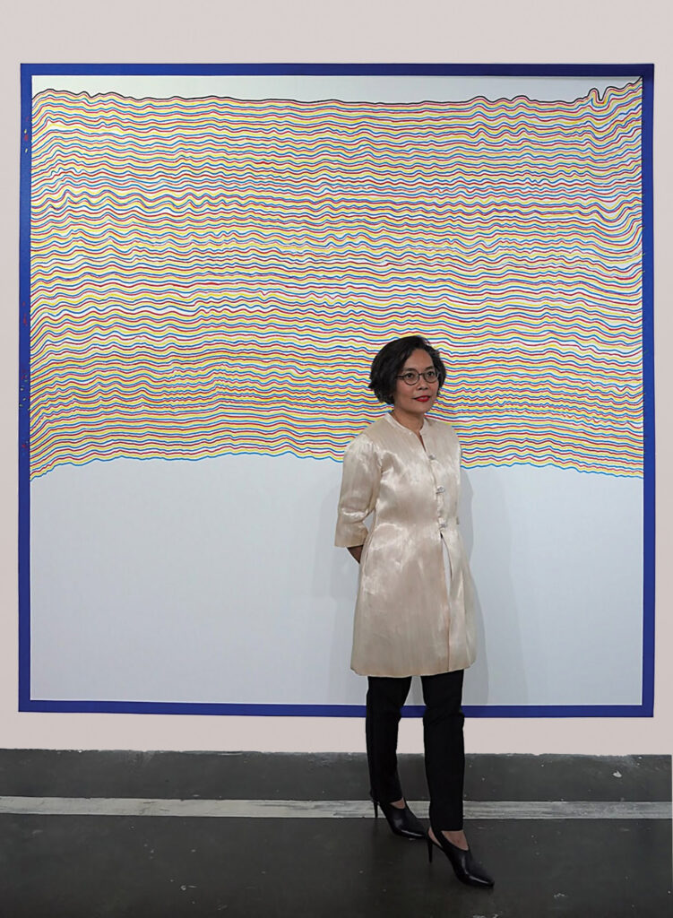 CE in front of Sol LeWitt's Wall Drawing #869A in progress at Art Fair Philippines
