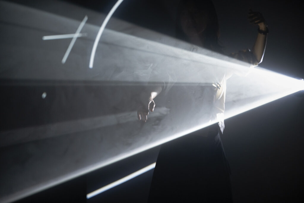 Anthony McCall Solid Light, figure in a beam of light at Tate Modern
