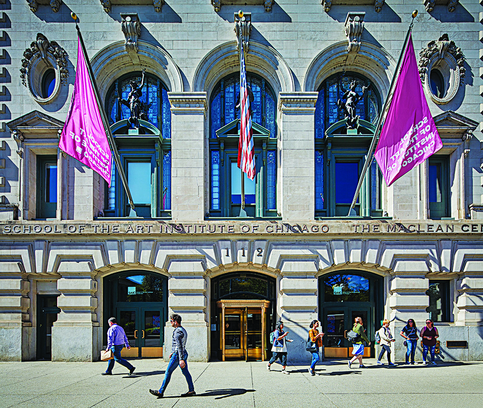 Front facade of the School of the Art Institute of Chicago's MacLean Center building, with purple flags above the entrance, a U.S. flag at the center, and pedestrians walking along the sidewalk.