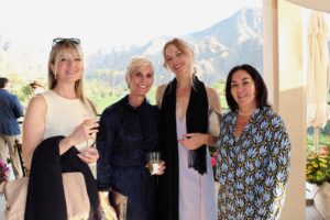 four women pose for a photo in Palm Springs with mountains in the background
