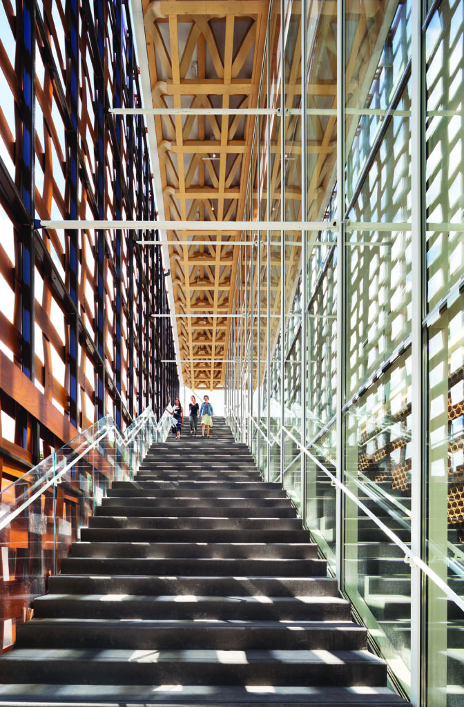 three small human figures descend a massive staircase at the modern Aspen Art Museum