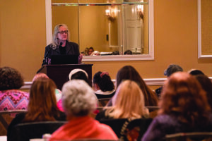 a speaker addresses a room full of animal advocates