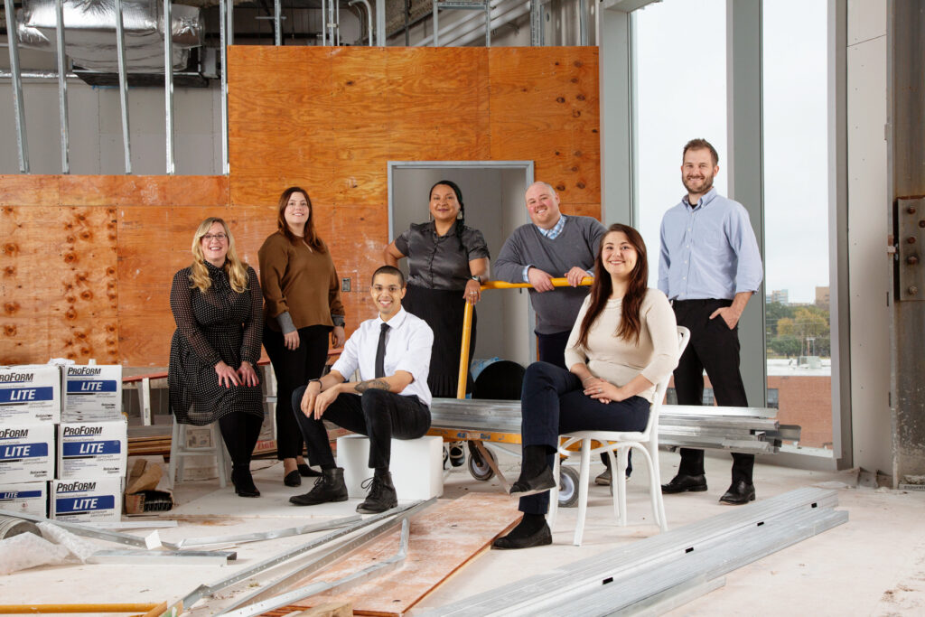 A group of professionals pose together in a professional setting
