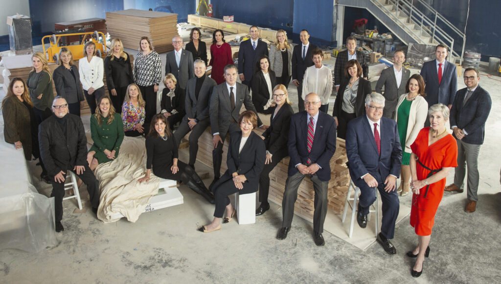 A group of people pose together in an industrial construction site