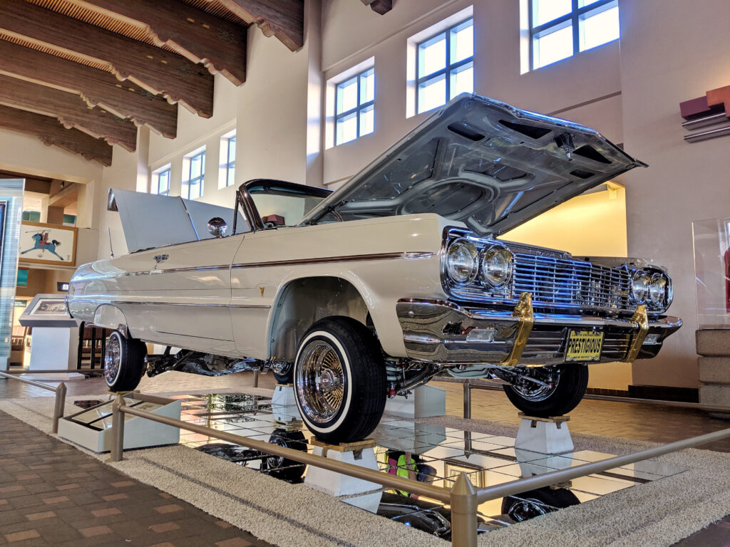 a decorative low riser car sits on display at an airport
