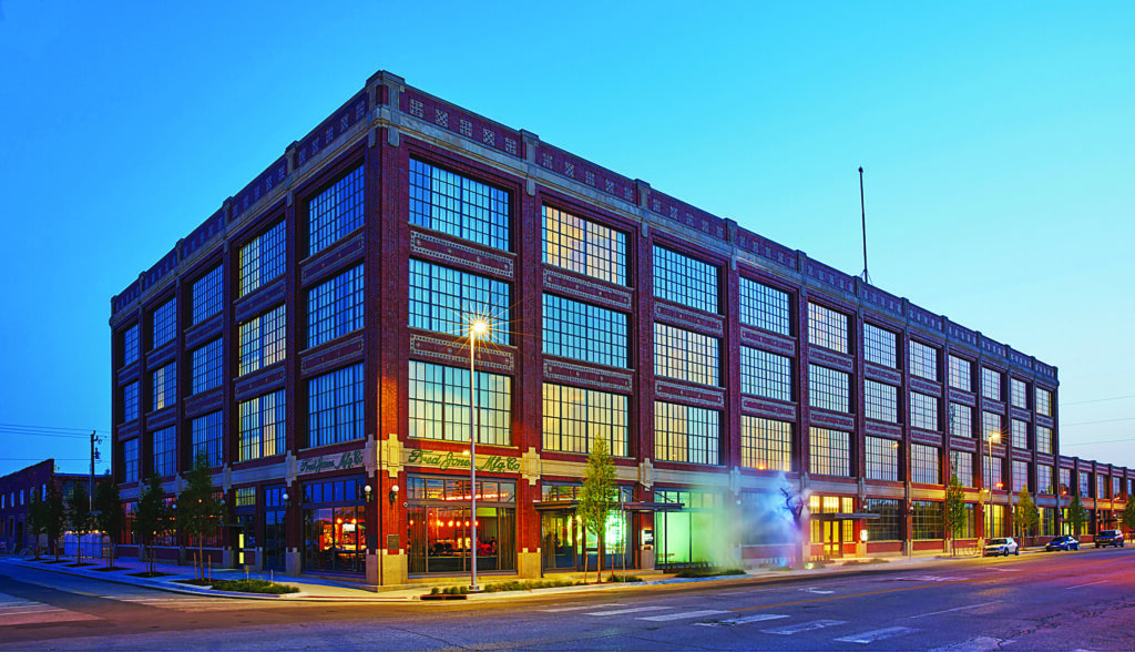 Corner facade of an older industrial plant at dusk