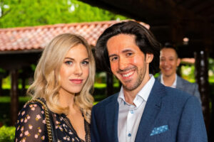 a couple poses for a photo in a garden setting