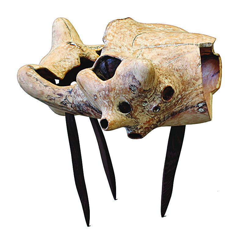 a rustic wooden three-legged sculpture