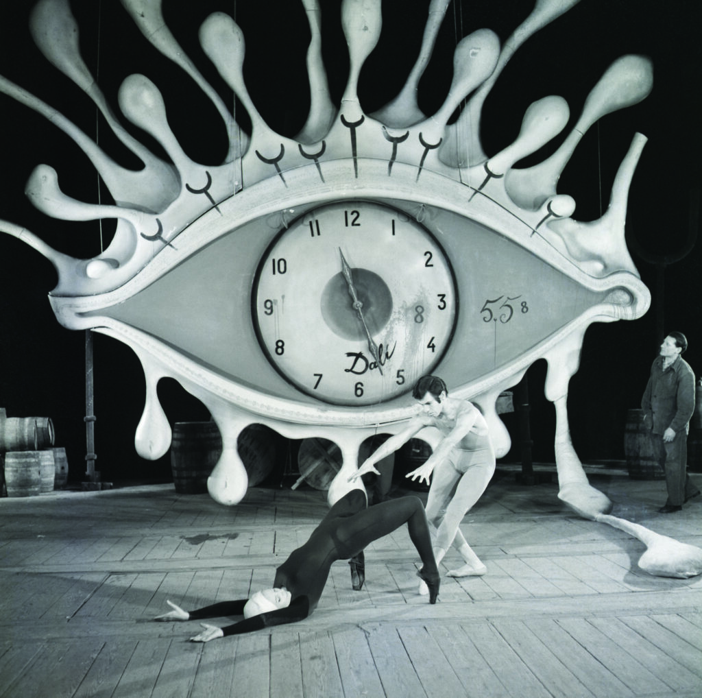 Ballerina And Partner Rehearse in front of Dali Clock, a clock within the iris of an eye where the eyelashes look like water droplets