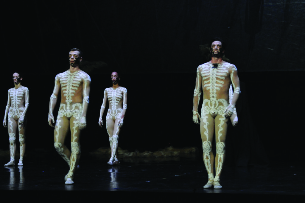 Ballet dancers in full body leotards featuring a skeleton applique take the stage