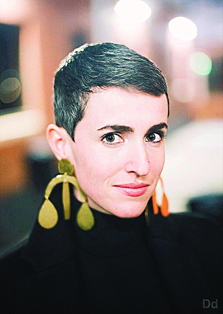a woman poses for a portrait in an outdoor, urban setting