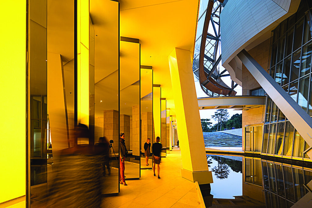 A bold art installation makes a wall, and its structural support beams, look bright yellow