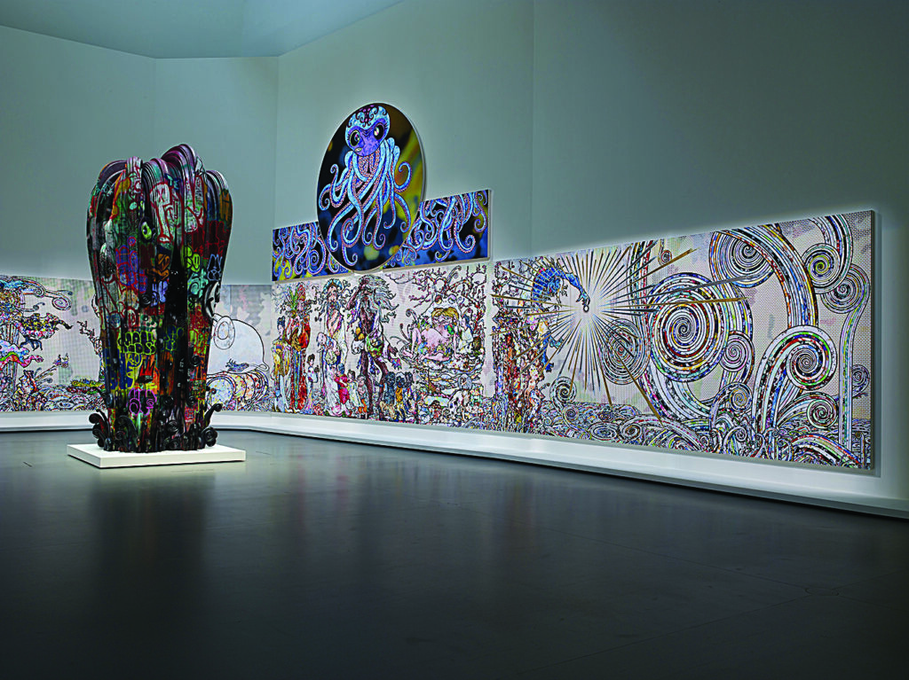 Contemporary art gallery installation featuring a large black sculptural column covered in colorful graffiti-style markings and expansive wall panels filled with intricate abstract patterns, swirling lines, and a central octopus illustration