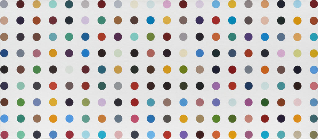 colored polkadots in perfect horizonal and vertical rows make up a white canvas