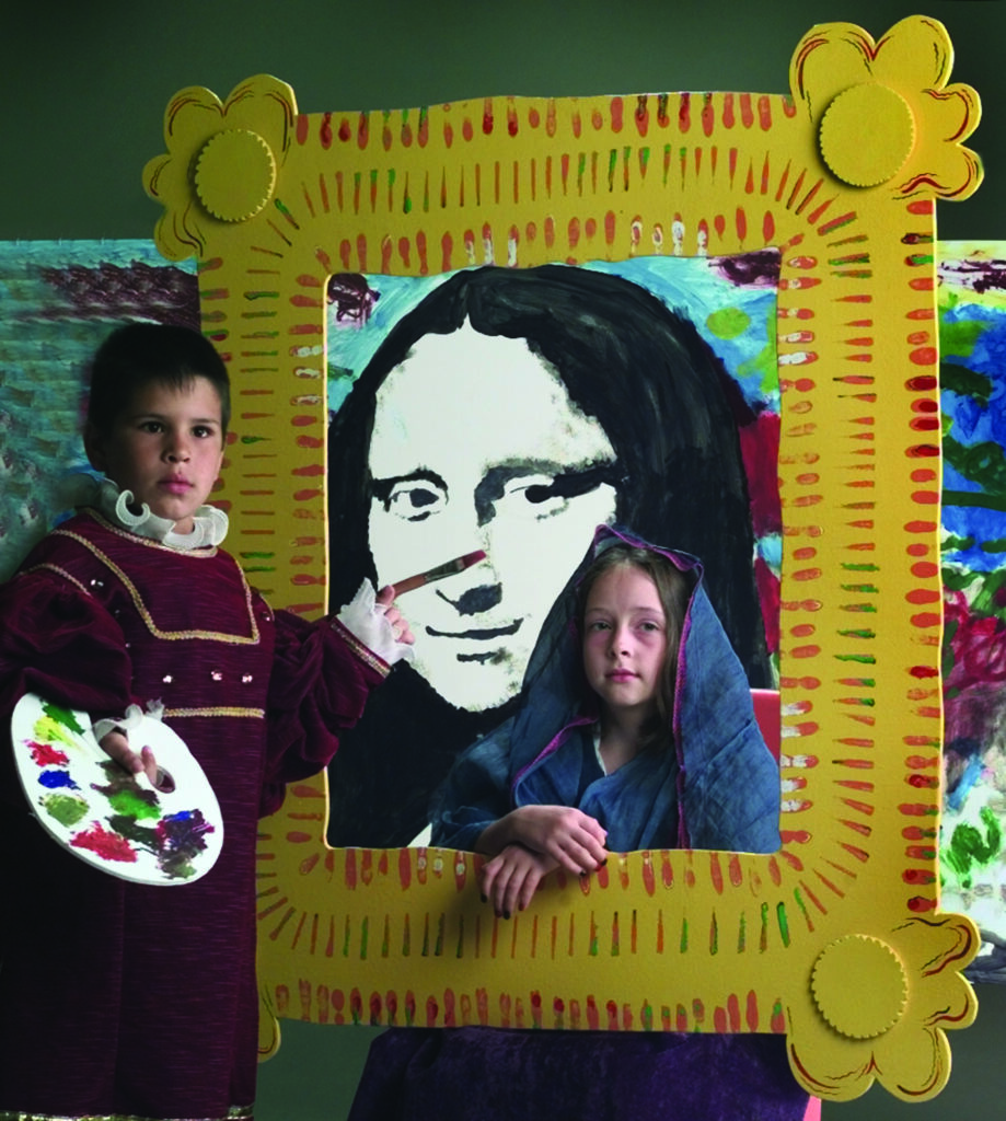 two art students participate in an interactive art set up by pretending to be a painter and by pretending to be a subject in a painting