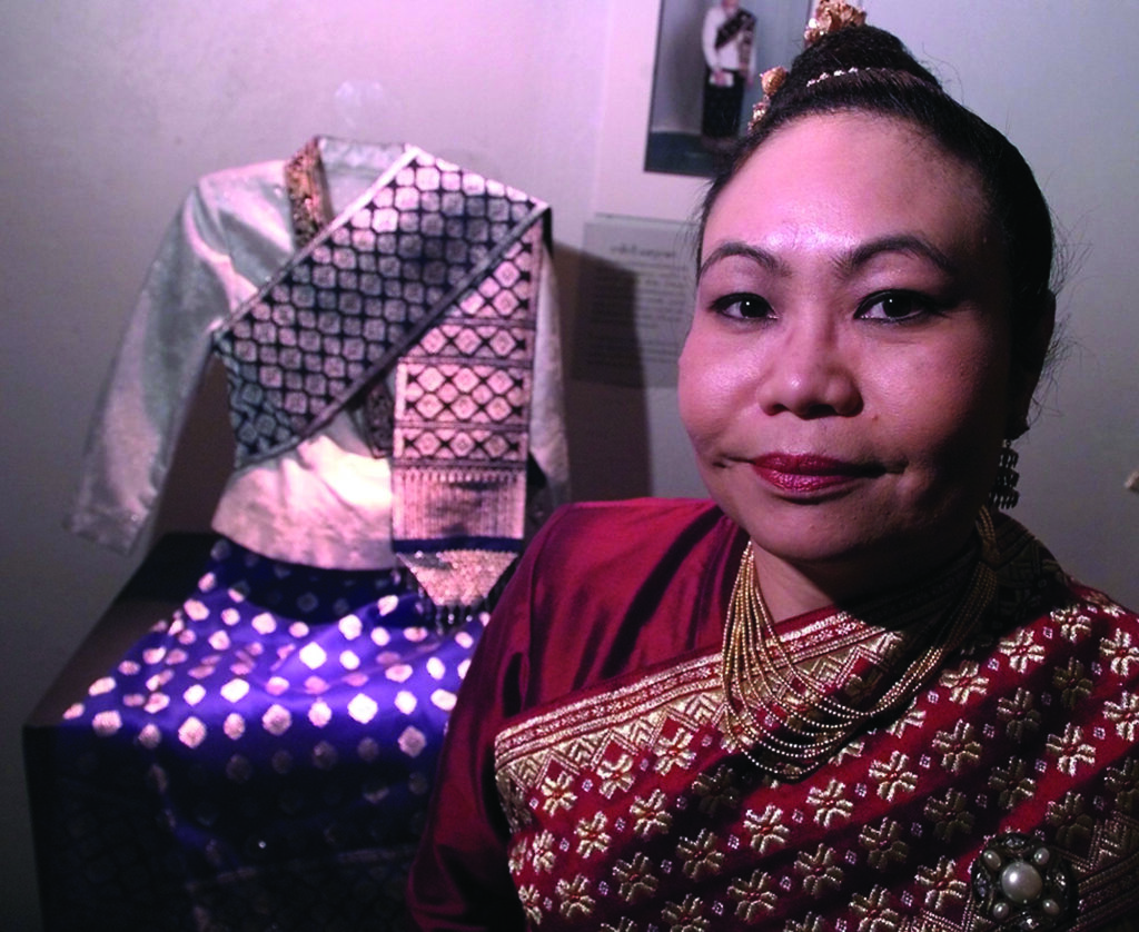 a textile artist poses with some of her work