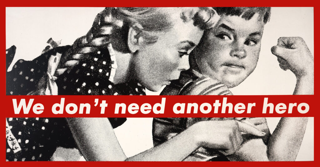 a young girl shows awe toward a young boy's bicep in a 1950s style illustration with the bold text " we don't need another hero" over the black and white artwork in red