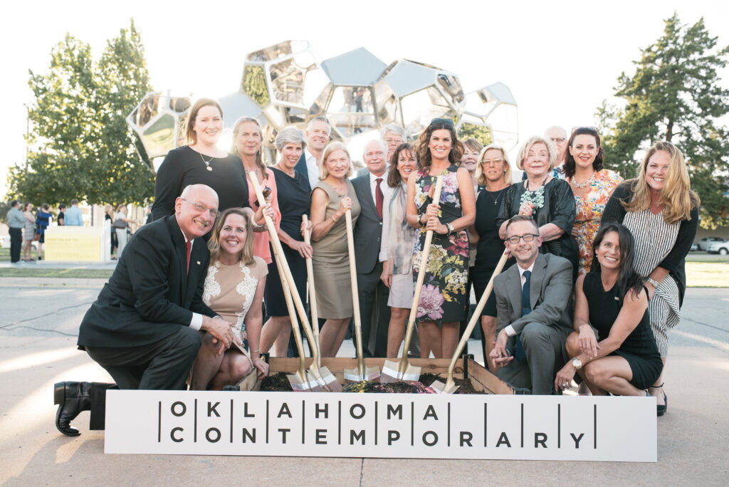 a group of people pose with shovels at a groundbreaking ceremony