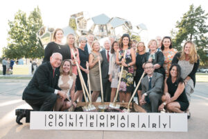 a group of people pose with shovels at a groundbreaking ceremony