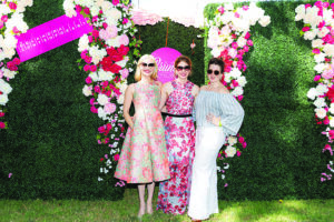 a group of people pose for a photo in a garden setting