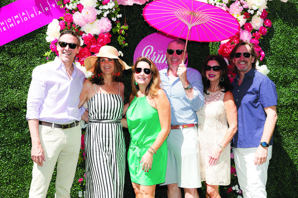 a group of people pose for a photo at a garden party