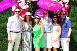 a group of people pose for a photo at a garden party