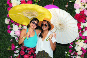 two people pose for a photo in a garden setting