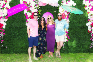 a group of people pose for a photo in a garden setting