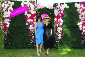 two people pose for a photo in a garden setting