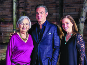 three people pose for a picture