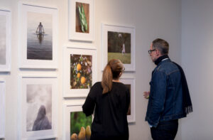 ArtNow attendees study the works of Eyakem Gulilat.