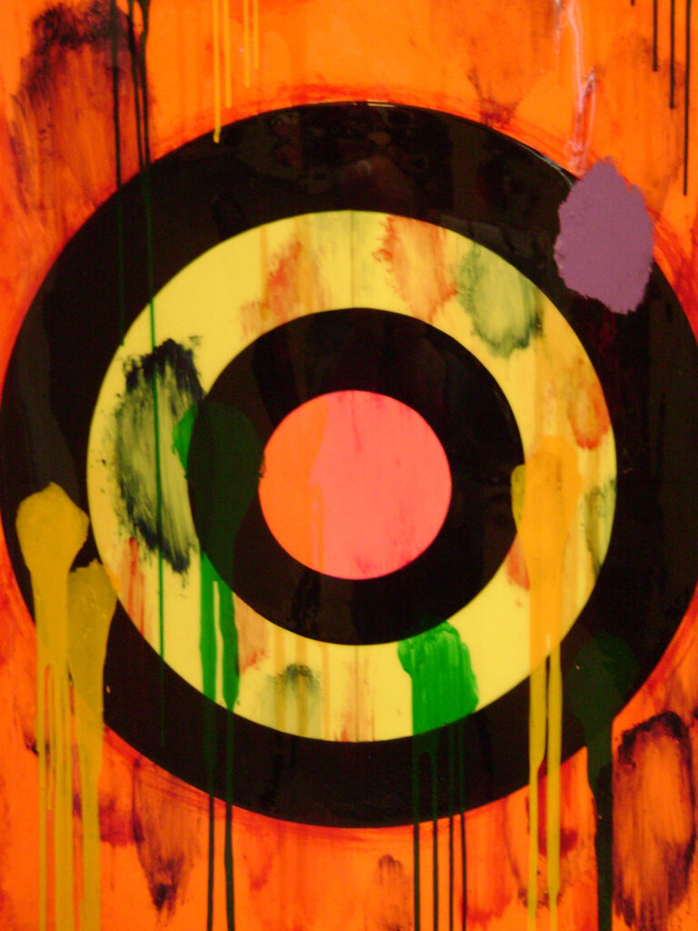 a painted bullseye target with red, orange and yellow punctuating black rings