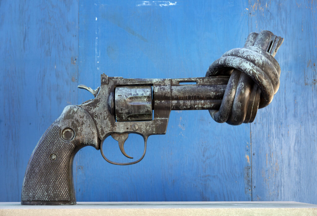 a metal gun with the barrel of the gun tied into a knot