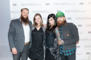 four people pose for a photo