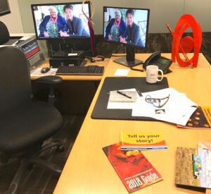 a clean desk with computer monitors and art guides