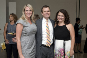 three people pose for a photo