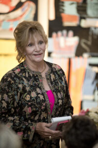 a woman speaks at a social event