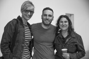 three people pose for a photo